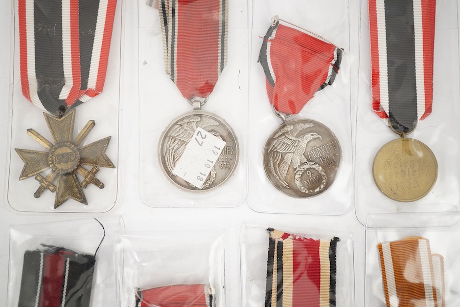 Nine German WWII medals; three Blood Order medals, a Second class Iron Cross, a War Merit medal in its original envelope, plus another unpacketed, a Second class War Merit cross, an Eastern Front Medal, and a West Wall M